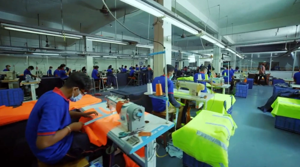Precision Uniform Production and Branding Workers producing uniforms with precise stitching and branding